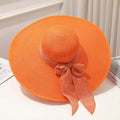Chapeau capeline orange à grand bord avec nœud